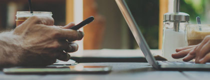 Man and woman working on their devices