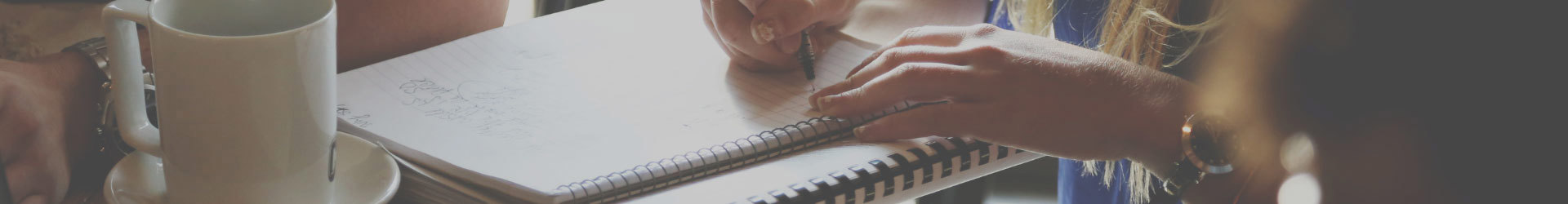 Woman writing notes on a note pad about IT Security