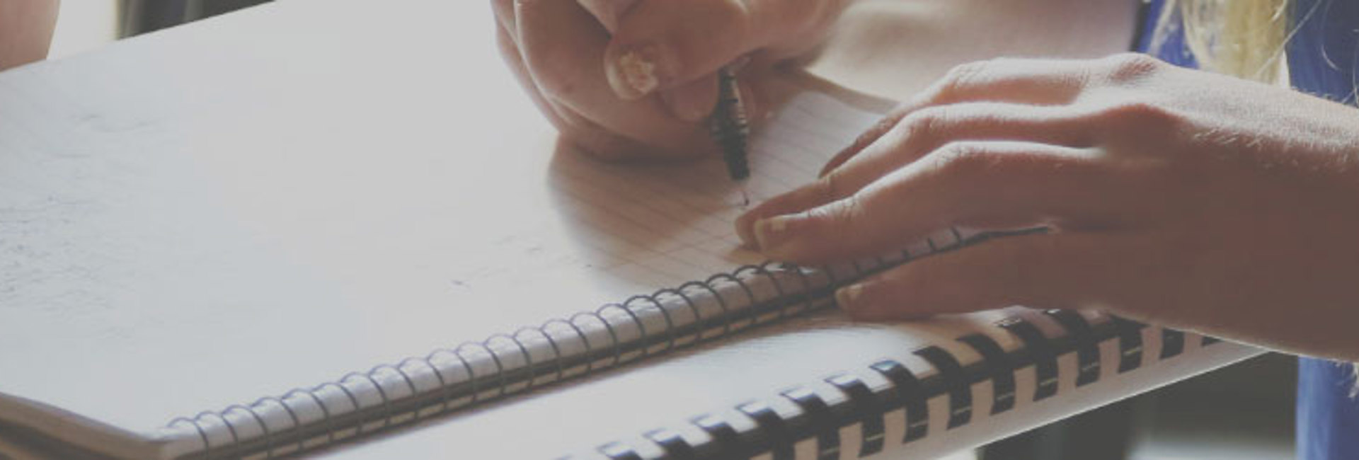 Woman writing notes on a note pad about IT Security