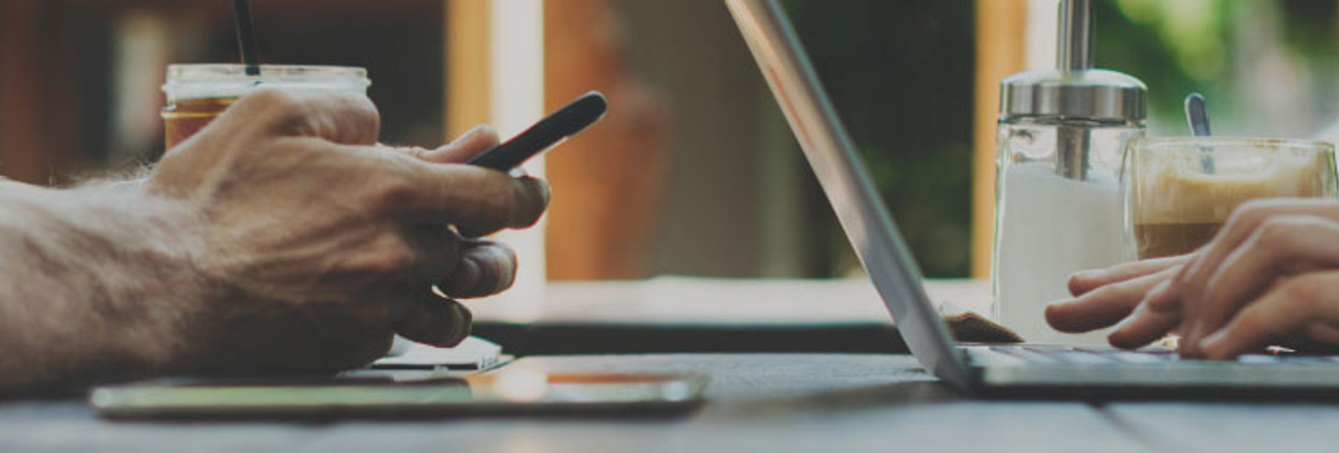 Man and woman working on their devices