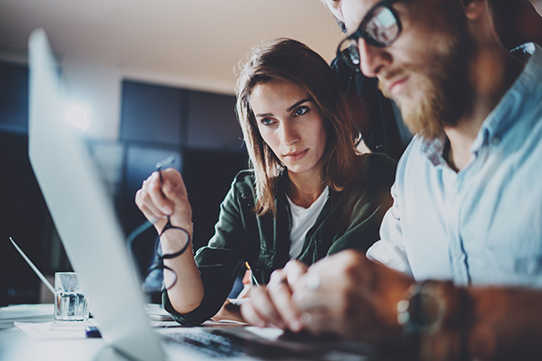 Business people reviewing IT Policies on a computer