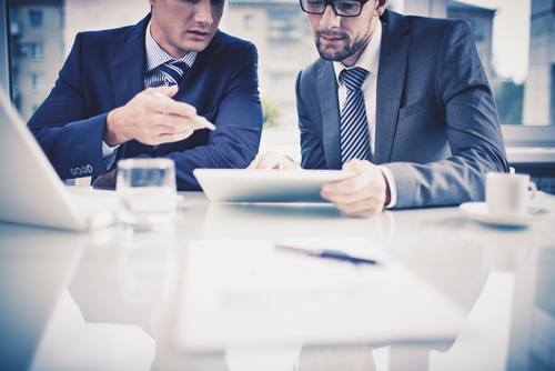 Two business men looking at the results of an IT Security Audit on a iPad