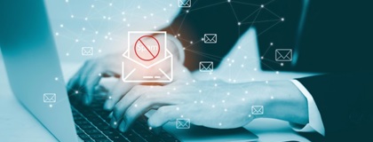 Business man working on a laptop conducting a email security & phishing threat assessment