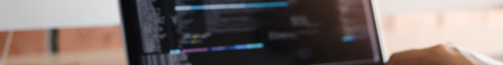 A close up a persons hands typing on a laptop updating their firewall rules