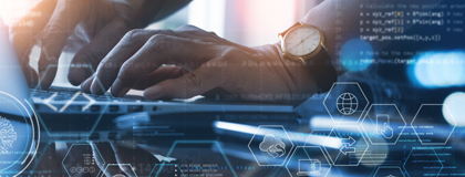 A mans hands typing on a laptop keyboard conducting a pen test