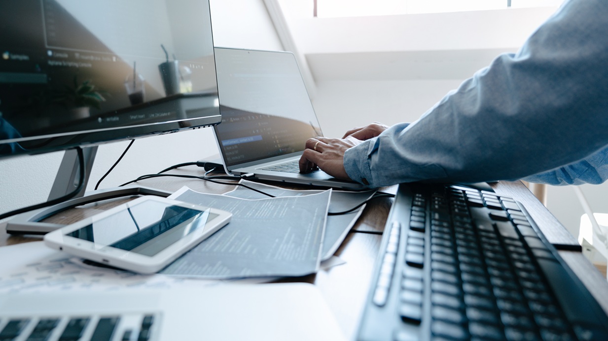 A businessman working through an Incident response plan on a laptop