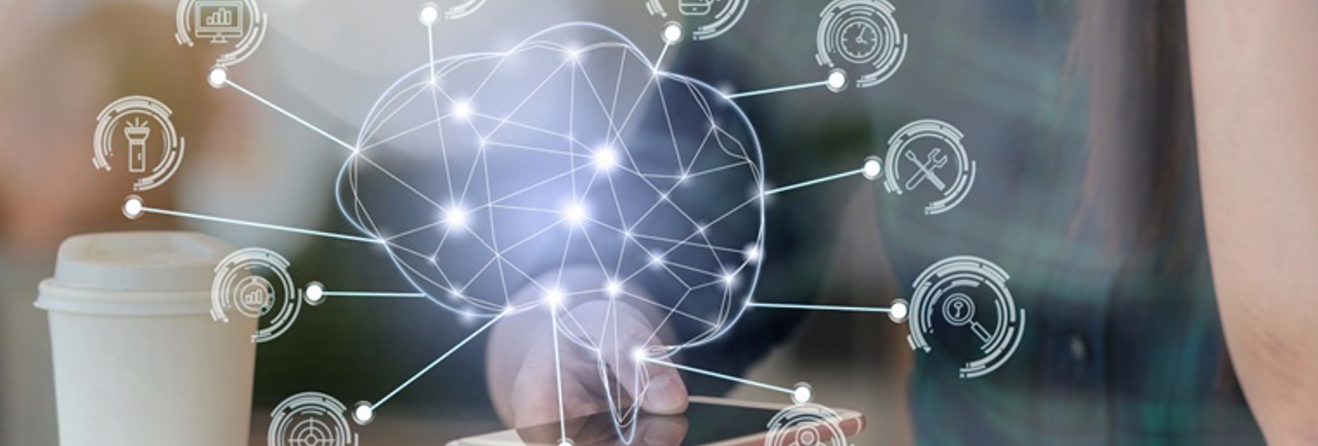 A woman with a laptop looking at her phone with a holographic of an artificial Intelligence brain