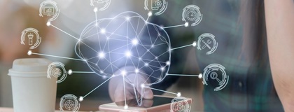 A woman with a laptop looking at her phone with a holographic of an artificial Intelligence brain