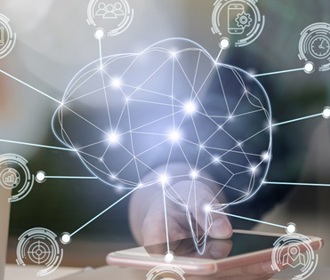 A woman with a laptop looking at her phone with a holographic of an artificial Intelligence brain 