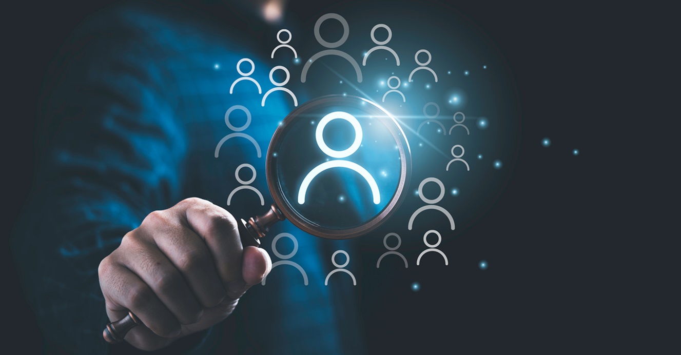 Man holding a magnifying glass assessing his third-party cyber risk management program