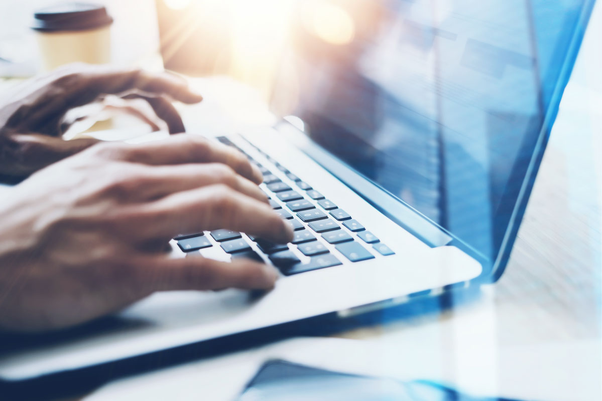 Professional reviewing firewall security configurations and assessment information on a laptop during a firewall security review.
